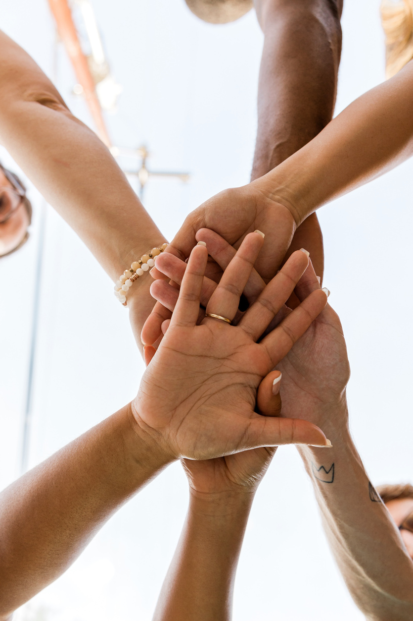 Colleagues Putting Their Hands Together in a Huddle